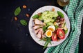 Ketogenic diet. Boiled egg, pork steak and olives, cucumber, spinach, brie cheese, nuts and tomato. Top view Royalty Free Stock Photo