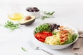 Ketogenic lunch bowl: spiralized courgette with avocado, tomato, feta cheese, olives, bacon