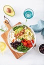 Ketogenic lunch bowl: spiralized courgette with avocado, tomato, feta cheese, olives, bacon