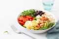 Ketogenic lunch bowl: spiralized courgette with avocado, tomato, feta cheese, olives, bacon