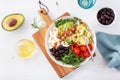 Ketogenic lunch bowl: spiralized courgette with avocado, tomato, feta cheese, olives, bacon