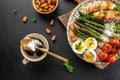 Ketogenic menu. Baked chicken breast wrapped in bacon with asparagus, eggs and tomatoes. bulletproof coffee with MCT coconut oil. Royalty Free Stock Photo