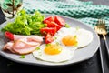 Ketogenic/paleo diet. Fried eggs, ham and fresh salad. Keto breakfast.