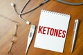 KETONES text written on paper with a stethoscope. Medical
