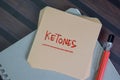 Ketones write on sticky notes isolated on Wooden Table Royalty Free Stock Photo
