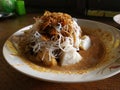 Ketoprak Betawi. Traditional street food dish of rice cake, rice noodles, bean curd, egg, and sprouts with peanut dressing.