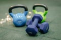 Kettle bells in a Gym. Christmas fitness composition with blue dumbbells, gift on white background with bokeh and show. Greeting