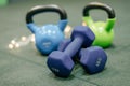 Kettle bells in a Gym. Christmas fitness composition with blue dumbbells, gift on white background with bokeh and show. Greeting