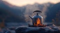 Kettle boiling on campfire stones with mountains in the background at sunset Royalty Free Stock Photo