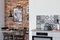 Electric stove in trendy kitchen with brick wall in dining room Royalty Free Stock Photo