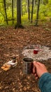 A kettle with natural herbal tea outside in nature near the fire. Living a healthy life close to nature Royalty Free Stock Photo