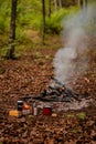 A kettle with natural herbal tea outside in nature near the fire. Living a healthy life close to nature Royalty Free Stock Photo