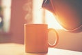 Kettle pouring boiling water into cup Royalty Free Stock Photo