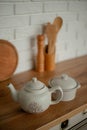 Kettle and saucepan on the kitchen table. kitchen appliances against a white kitchen background Royalty Free Stock Photo