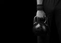 Close-up of a muscular hand holding a kettlebell