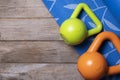 Kettlebell and blue yoga mat on table, fitness healthy and sport concept Royalty Free Stock Photo