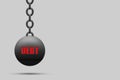 Kettlebell with a chain, the word Debt, on a gray background. copy space. The severity of obligations. Business. Finance