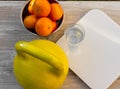 Kettlebell, tangerines, scales and glass of water Royalty Free Stock Photo