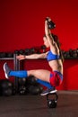 Kettlebell woman pistol squat balance at gym