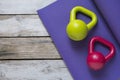 Kettlebell and yoga mat on table Royalty Free Stock Photo