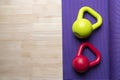 Kettlebell with yoga mat on wooden table Royalty Free Stock Photo