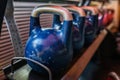 Kettlebells in a rack at the gym. Free weights close up. Royalty Free Stock Photo