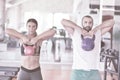 Kettlebells swing exercise man and woman workout at gym