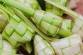 Ketupat casing and rice in bamboo container.