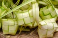 Ketupat casing and rice in bamboo container.