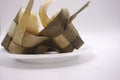 a ketupat that has been split in half on a plastic plate, photo taken front Royalty Free Stock Photo