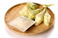 Ketupat rice dumpling and rice on traditional woven tray