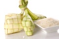 Ketupat rice dumpling and rice on traditional woven tray