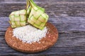 Ketupat Rice Dumpling and rice On Wood Background. Ketupat is