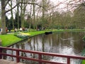 Keukenhof, Holland- april 04, 2007: central part of the park, a pond, tall trees, beautiful flower beds