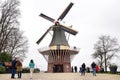 Keukenhof Lisse, The Netherlands - 21 March , 2019: Tourists on background of old dutch windmill, symbol of Holland