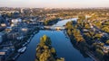 Idyllic scene of a peaceful river, surrounded by lush green trees and city buildings. London