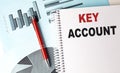 KEY ACCOUNT text on a notebook with pen on a chart background Royalty Free Stock Photo