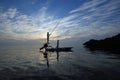 Fishermen pole flats boat over Bear Cur shallows off Key Biscayne at sunrise. Royalty Free Stock Photo