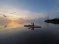 Woman kayaking at sunrise in Bear Cut, Florida.