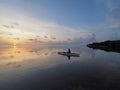 Woman kayaking at sunrise in Bear Cut, Florida.