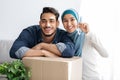 Key chain in smiling muslim couple hands, moving concept Royalty Free Stock Photo