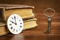 Key with clock and books, life coaching, solution concept Royalty Free Stock Photo