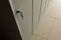 The key in the door lock of a personal metal cabinet for students. Copy space. School hall, locker room for athletes or office