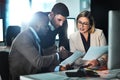 They are the key go-to team. three businesspeople discussing paperwork.