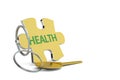 Key and golden keyring with the word health on white background Royalty Free Stock Photo