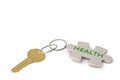 Key and golden keyring with the word health on white background Royalty Free Stock Photo