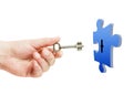 Key in hand opening puzzle lock over white Royalty Free Stock Photo