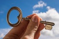 Key into hand, Sky Background Royalty Free Stock Photo