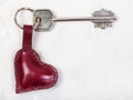 Key with heart shape keychain on concrete board Royalty Free Stock Photo