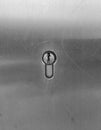 Key hole in solid steel / metal door. Vertical image with keyhole in centre.